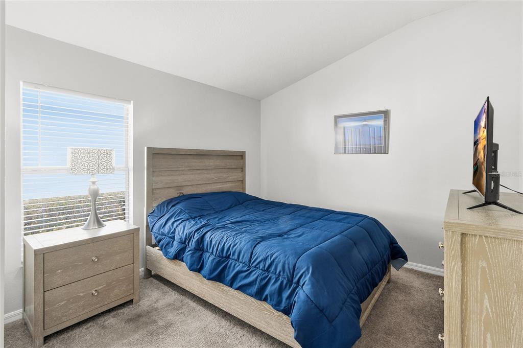 6641 Boulder Run Loop Wesley Chapel, FL 33545 - Photo 26 of 43 a bedroom with a bed and a window