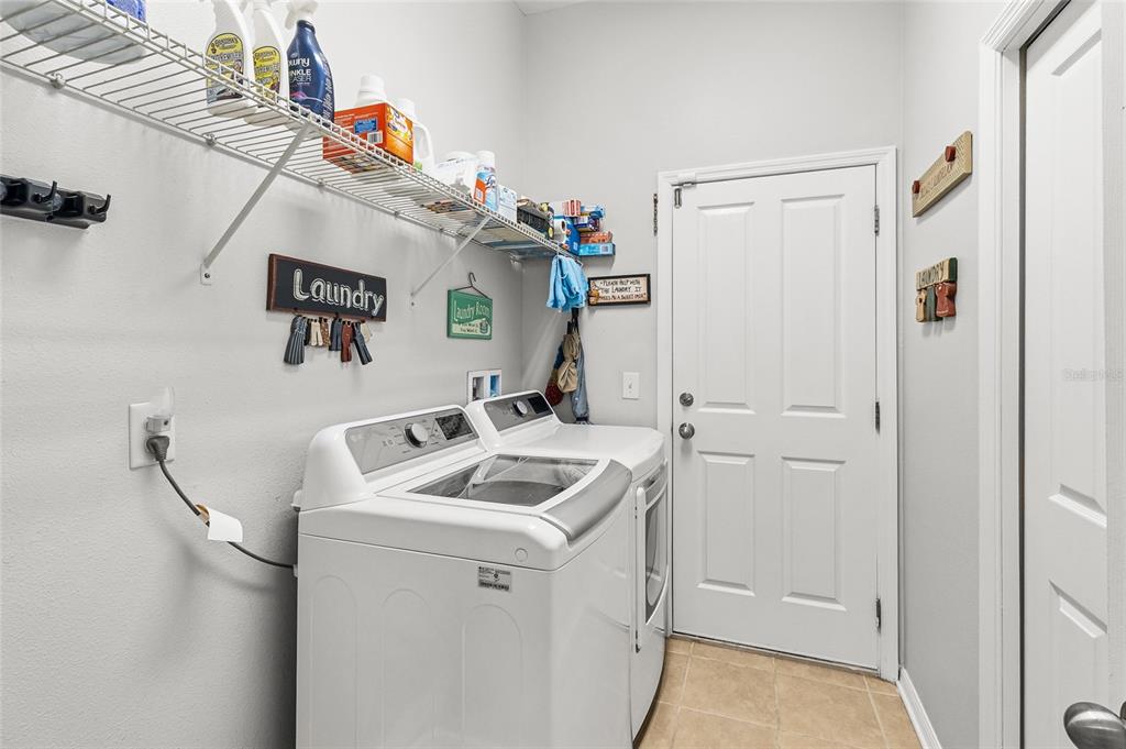 6641 Boulder Run Loop Wesley Chapel, FL 33545 - Photo 33 of 43 a bathroom with a sink and a washer dryer