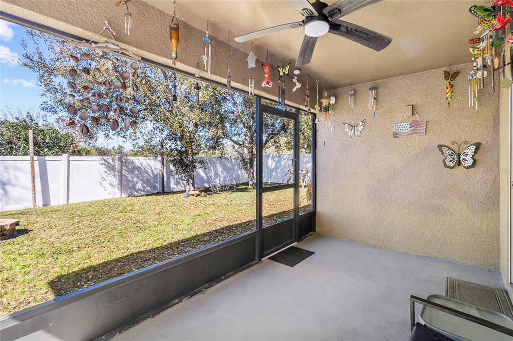 6641 Boulder Run Loop Wesley Chapel, FL 33545 - Photo 35 of 43 a view of an empty room and kitchen with a ceiling fan