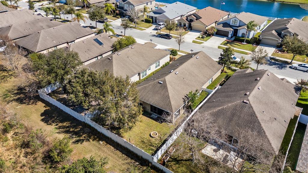 6641 Boulder Run Loop Wesley Chapel, FL 33545 - Photo 41 of 43 an aerial view of a house with a yard and lake view