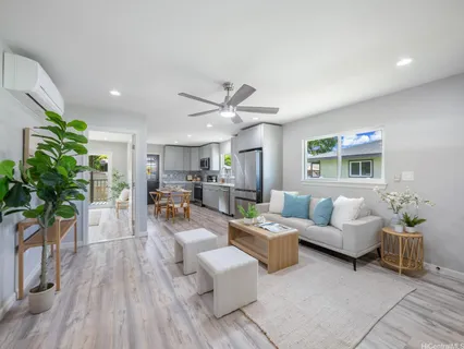 a living room with furniture and wooden floor