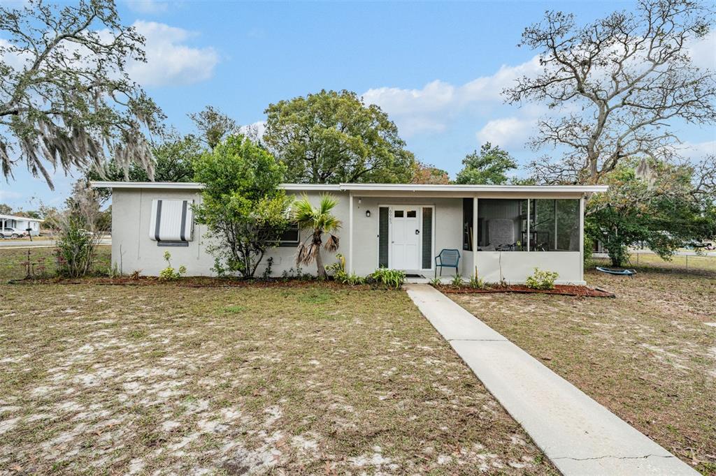 6985 Merrick Lane Spring Hill, FL 34606 - Photo 1 of 15 front view of house with a yard