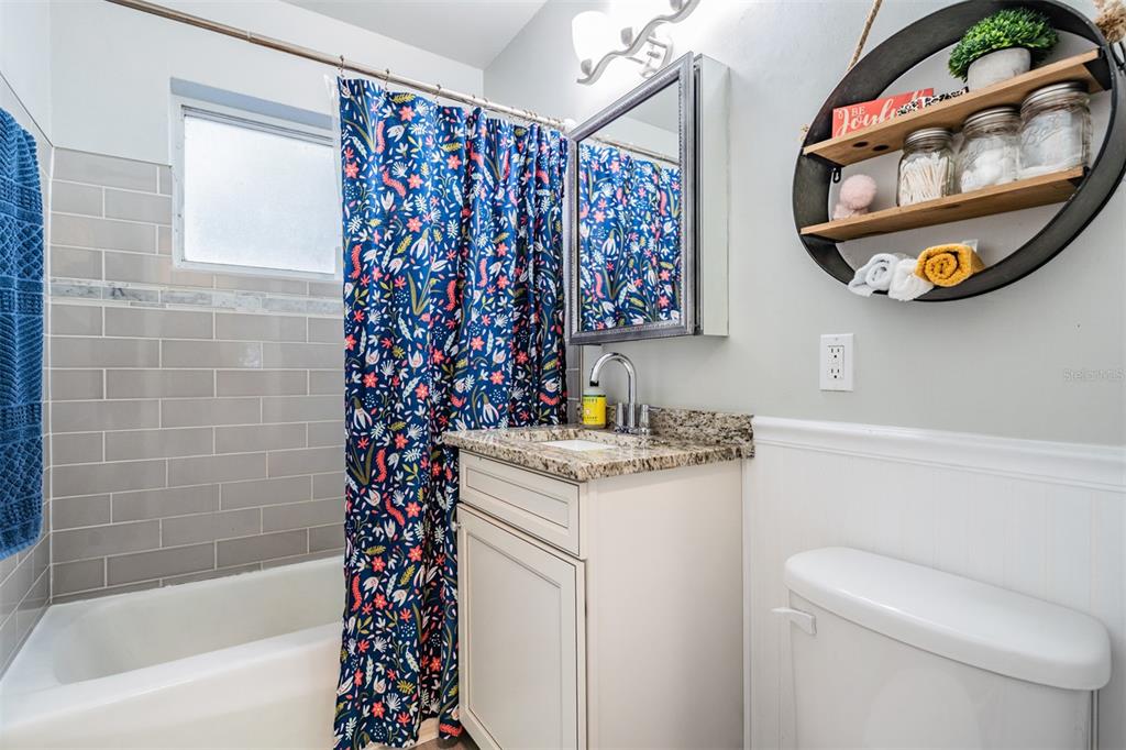 6985 Merrick Lane Spring Hill, FL 34606 - Photo 13 of 15 a bathroom with a granite countertop sink and a mirror
