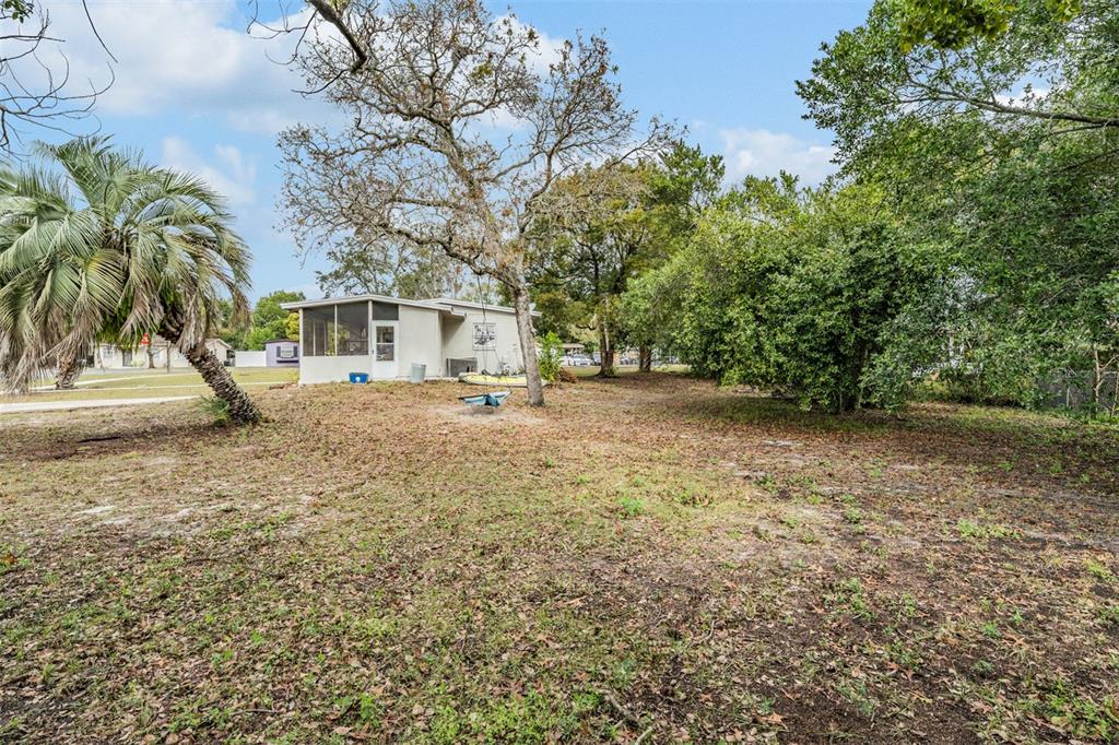 6985 Merrick Lane Spring Hill, FL 34606 - Photo 14 of 15 a view of outdoor space with deck and trees