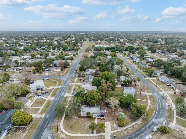 an aerial view of residential houses with outdoor space