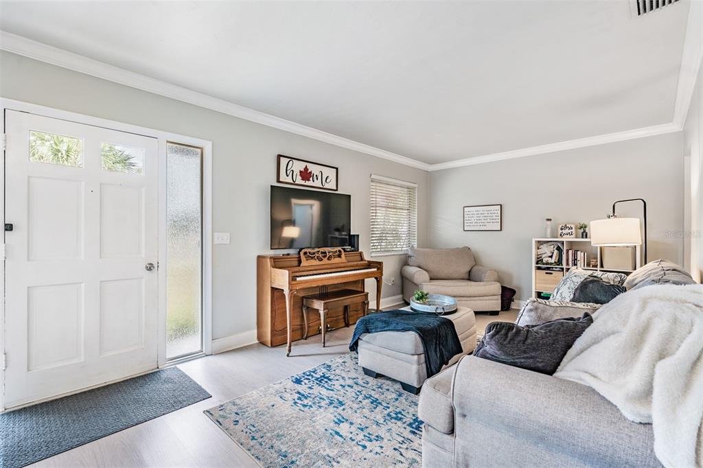 6985 Merrick Lane Spring Hill, FL 34606 - Photo 3 of 15 a living room with furniture and a flat screen tv