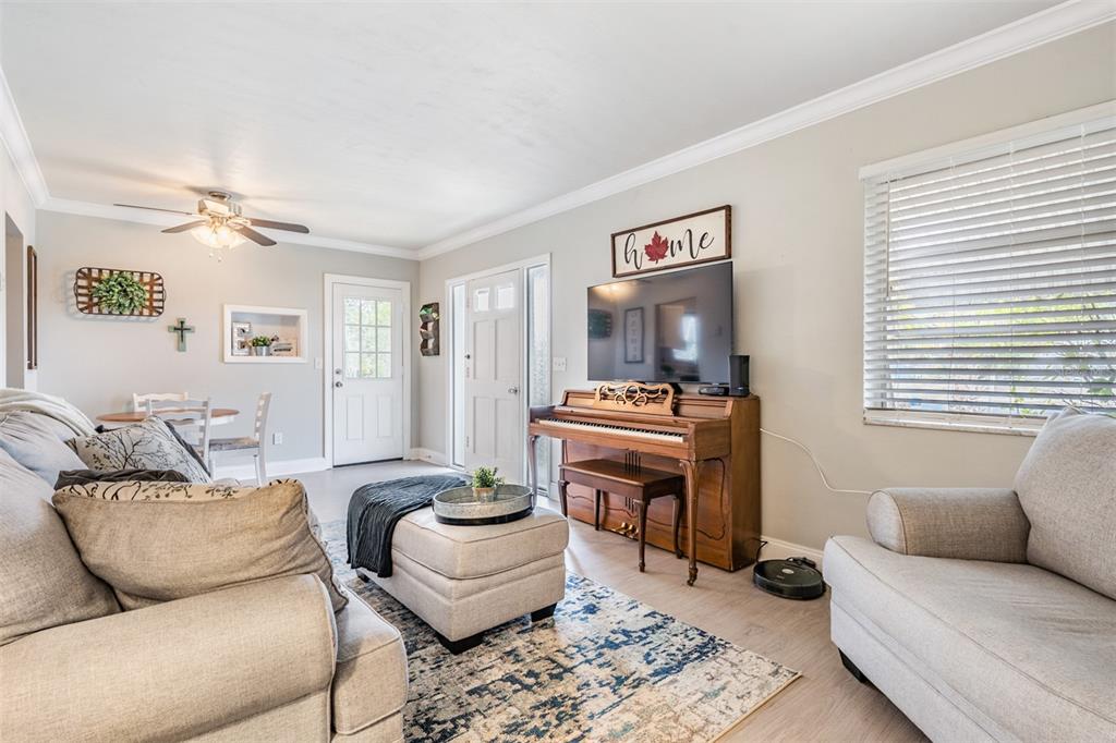 6985 Merrick Lane Spring Hill, FL 34606 - Photo 6 of 15 a living room with furniture a rug and a window