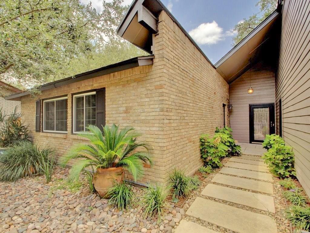 3607 Summit Bend, Unit B Austin, TX 78759 - Photo 1 of 24 a front view of a house with a yard