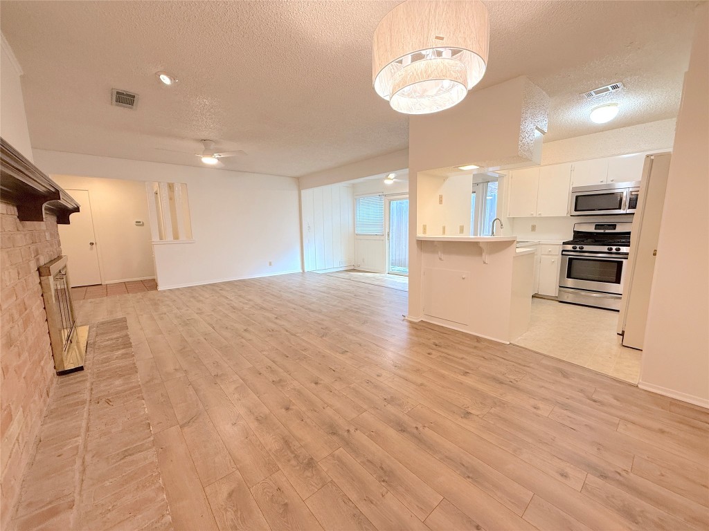 3607 Summit Bend, Unit B Austin, TX 78759 - Photo 5 of 24 a view of a kitchen with a sink and dishwasher a refrigerator with wooden floor