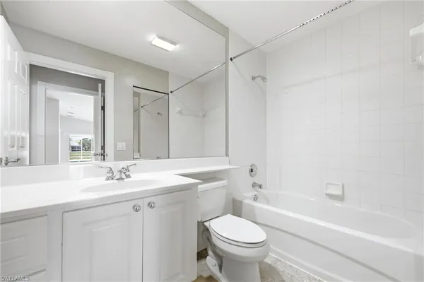 a bathroom with a sink toilet vanity and bathtub