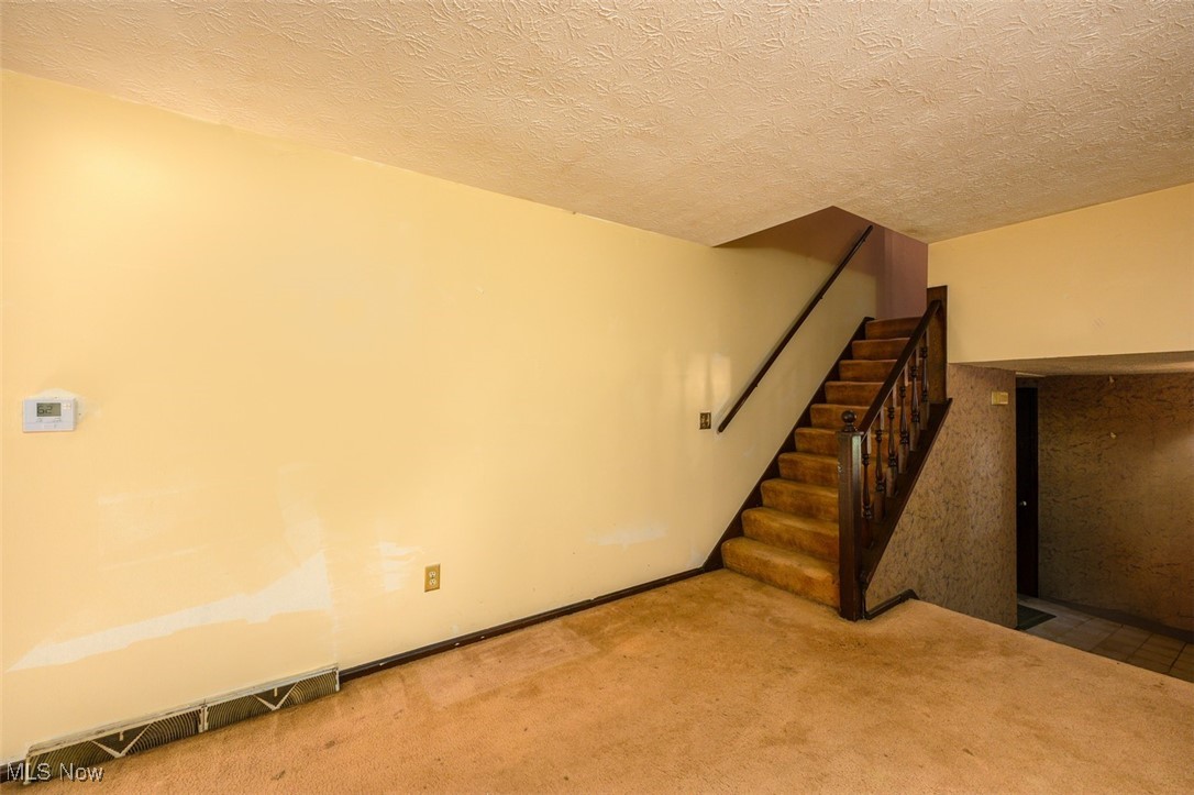 8838 Timberlink Road Northwest Canal Fulton, OH 44614 - Photo 3 of 30 Family room with carpeted floors