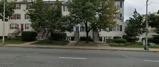 a view of a street with a building in the background