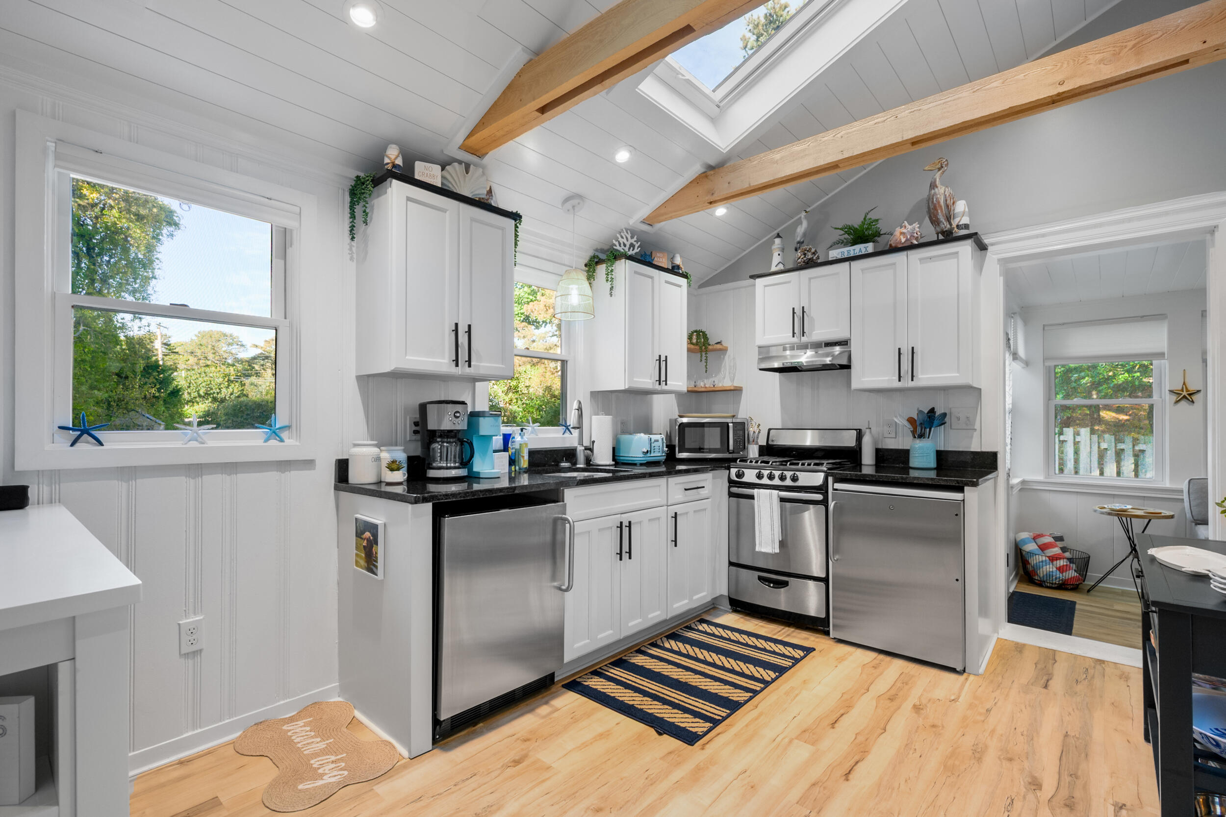 82 Shore Road, Unit 8 Truro, MA 02666 - Photo 11 of 40 a kitchen with a sink appliances cabinets and a window
