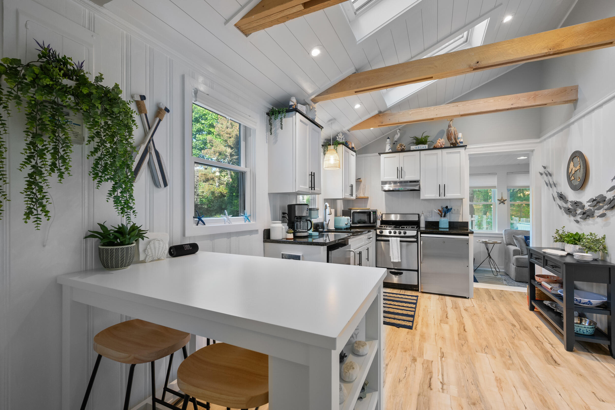 82 Shore Road, Unit 8 Truro, MA 02666 - Photo 12 of 40 a kitchen with sink refrigerator dining table and chairs