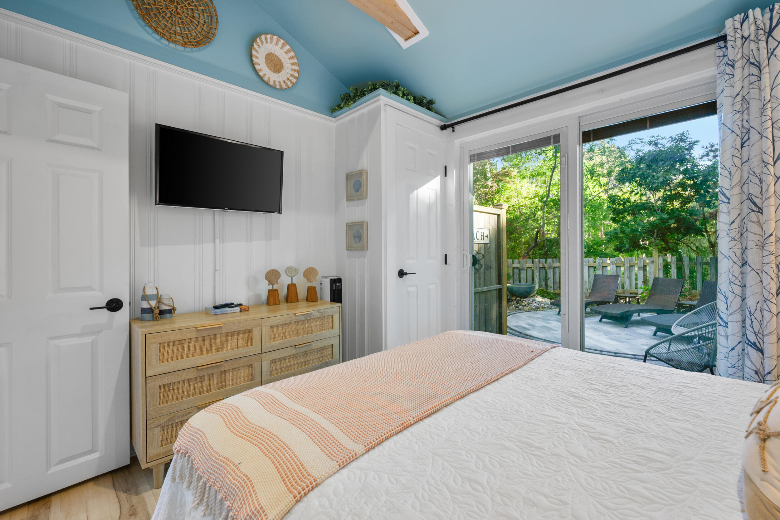 82 Shore Road, Unit 8 Truro, MA 02666 - Photo 16 of 40 a bedroom with a large bed and a flat tv screen on dresser