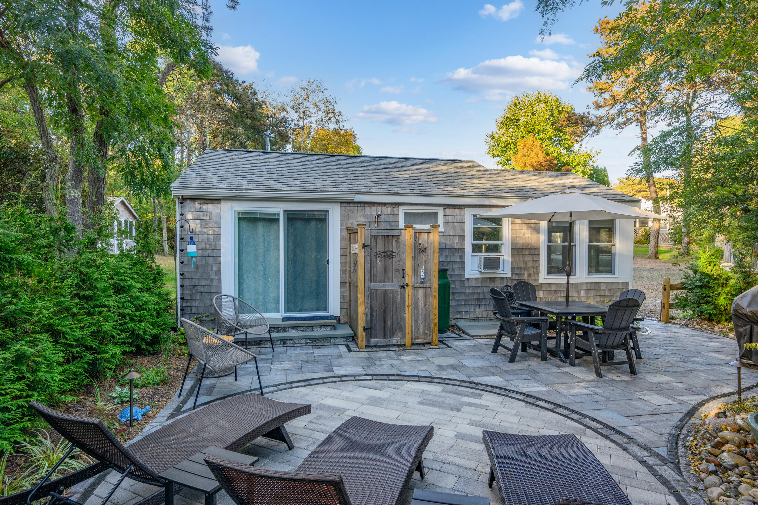 82 Shore Road, Unit 8 Truro, MA 02666 - Photo 29 of 40 a view of a house with a backyard and sitting area