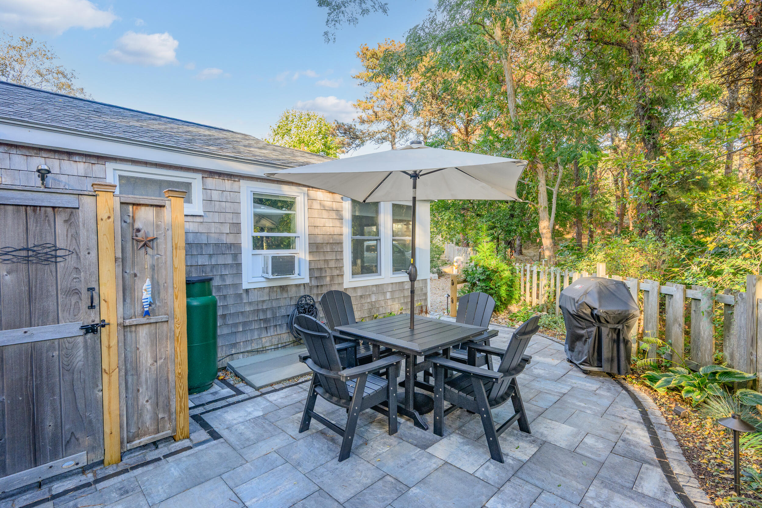 82 Shore Road, Unit 8 Truro, MA 02666 - Photo 30 of 40 a view of a patio with table and chairs and potted plants