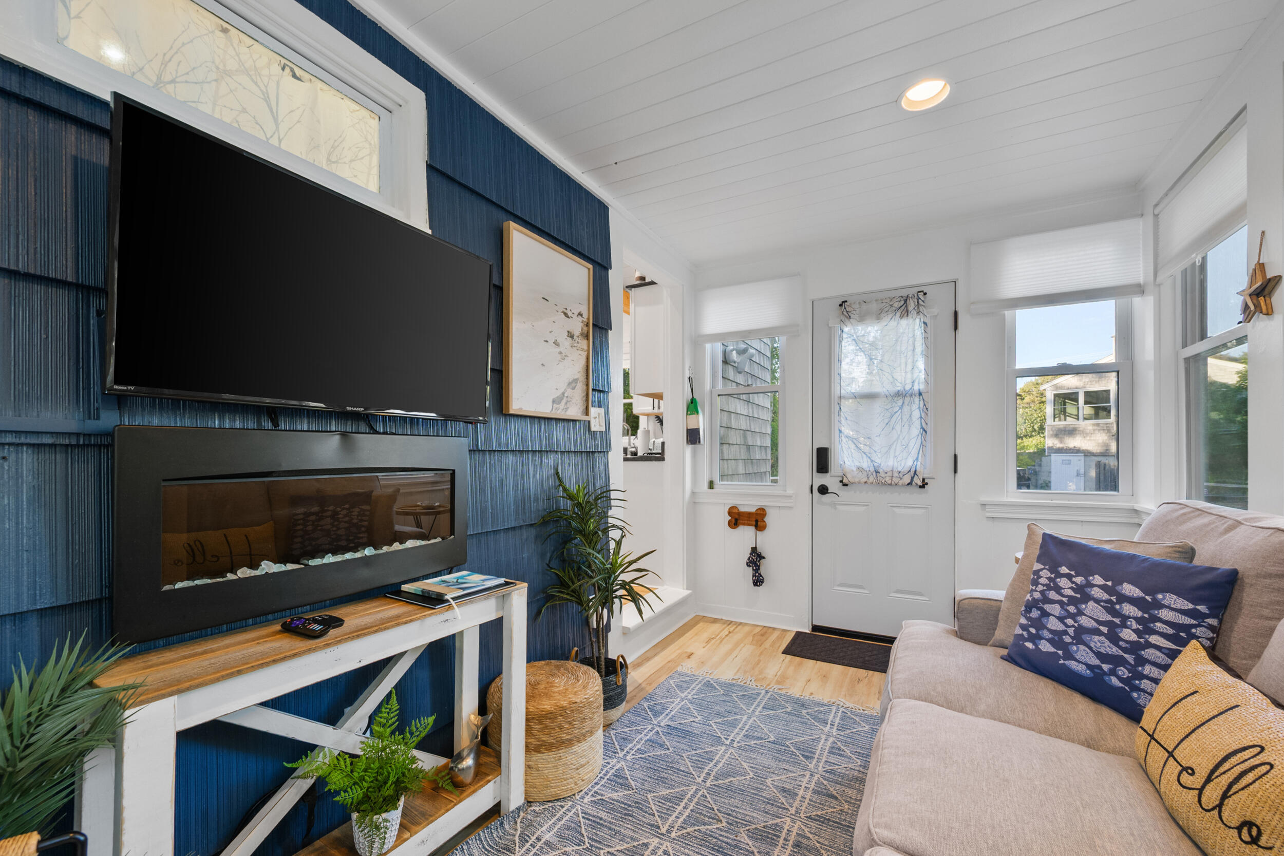82 Shore Road, Unit 8 Truro, MA 02666 - Photo 8 of 40 a living room with furniture a flat screen tv and a fireplace