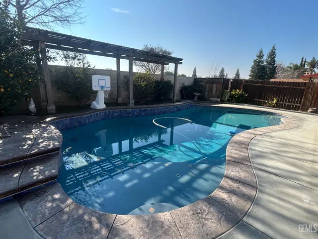 a view of backyard with outdoor seating and green space