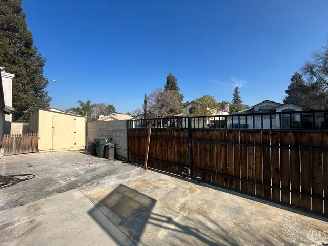 a kitchen with stainless steel appliances granite countertop a table chairs sink refrigerator and microwave