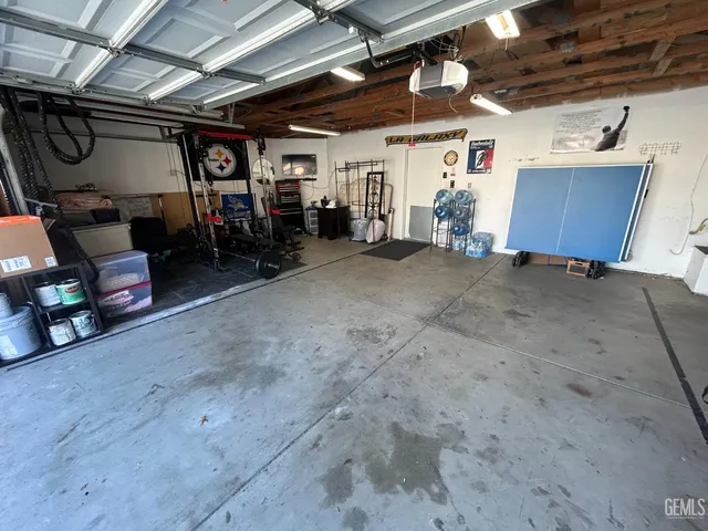 a bathroom with a double vanity sink a toilet a mirror and shower