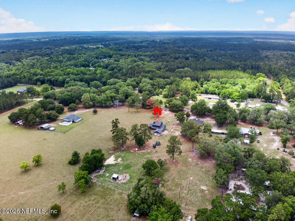 2955 Carroll Corner Road Hilliard, FL 32046 - Photo 98 of 106 an aerial view of house with yard and mountain view in back