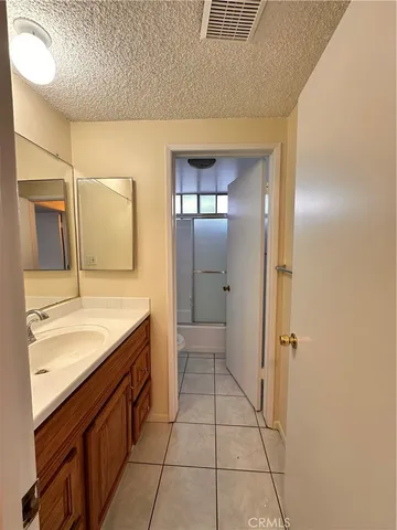 a spacious bathroom with a granite countertop sink a mirror and a