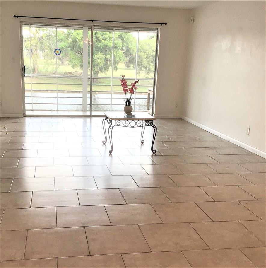 3551 Inverrary Drive, Unit 208 Lauderhill, FL 33319 - Photo 3 of 15 a white bath tub sitting in a bathroom next to a window