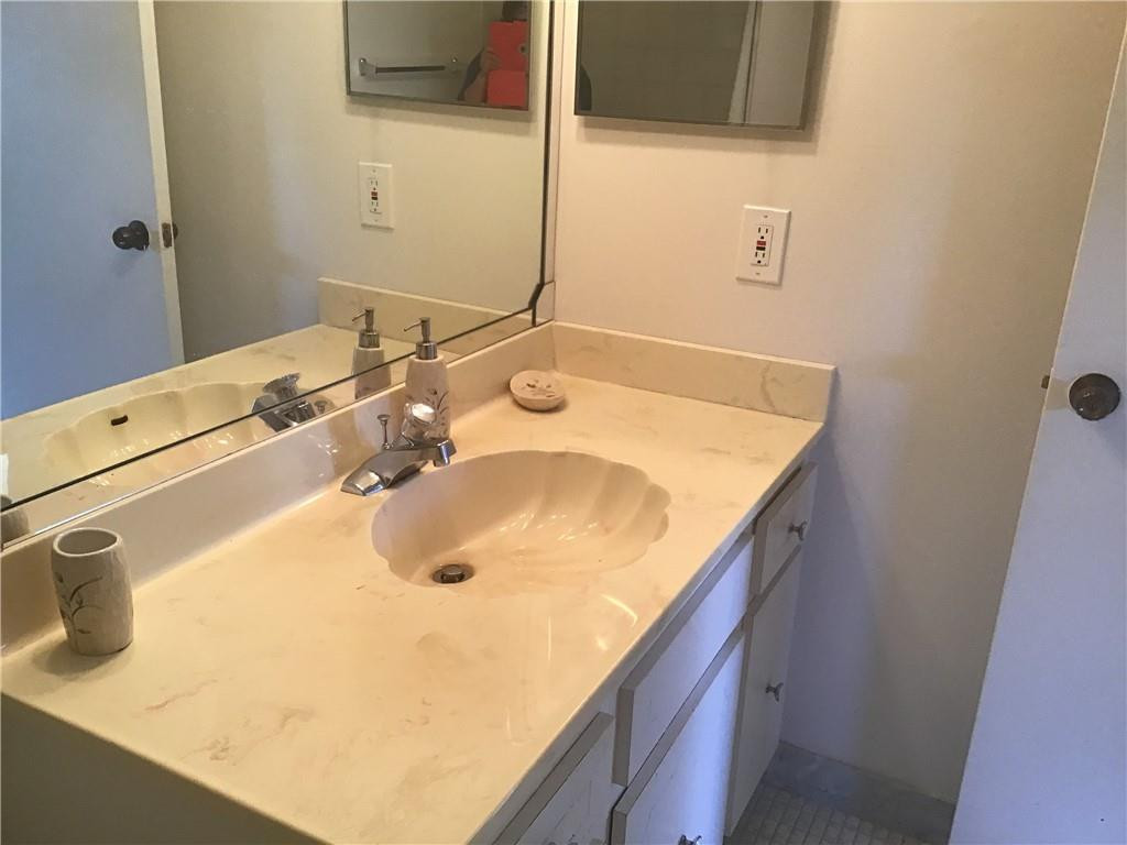 3551 Inverrary Drive, Unit 208 Lauderhill, FL 33319 - Photo 9 of 15 a bathroom with a sink and a mirror