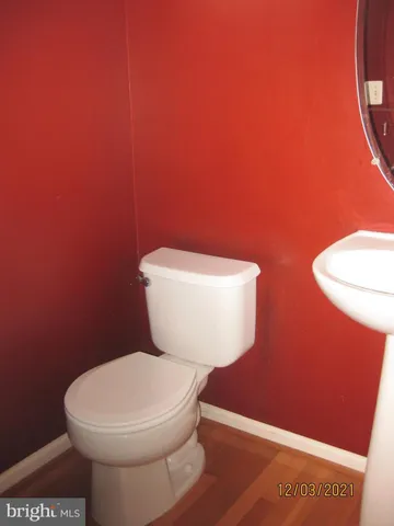 a white toilet sitting next to a shower