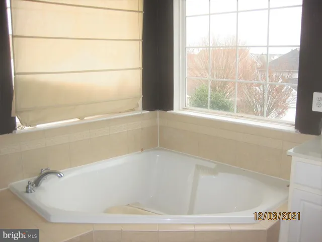 a white bath tub sitting next to a window