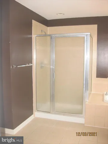 a bathroom with a glass shower door