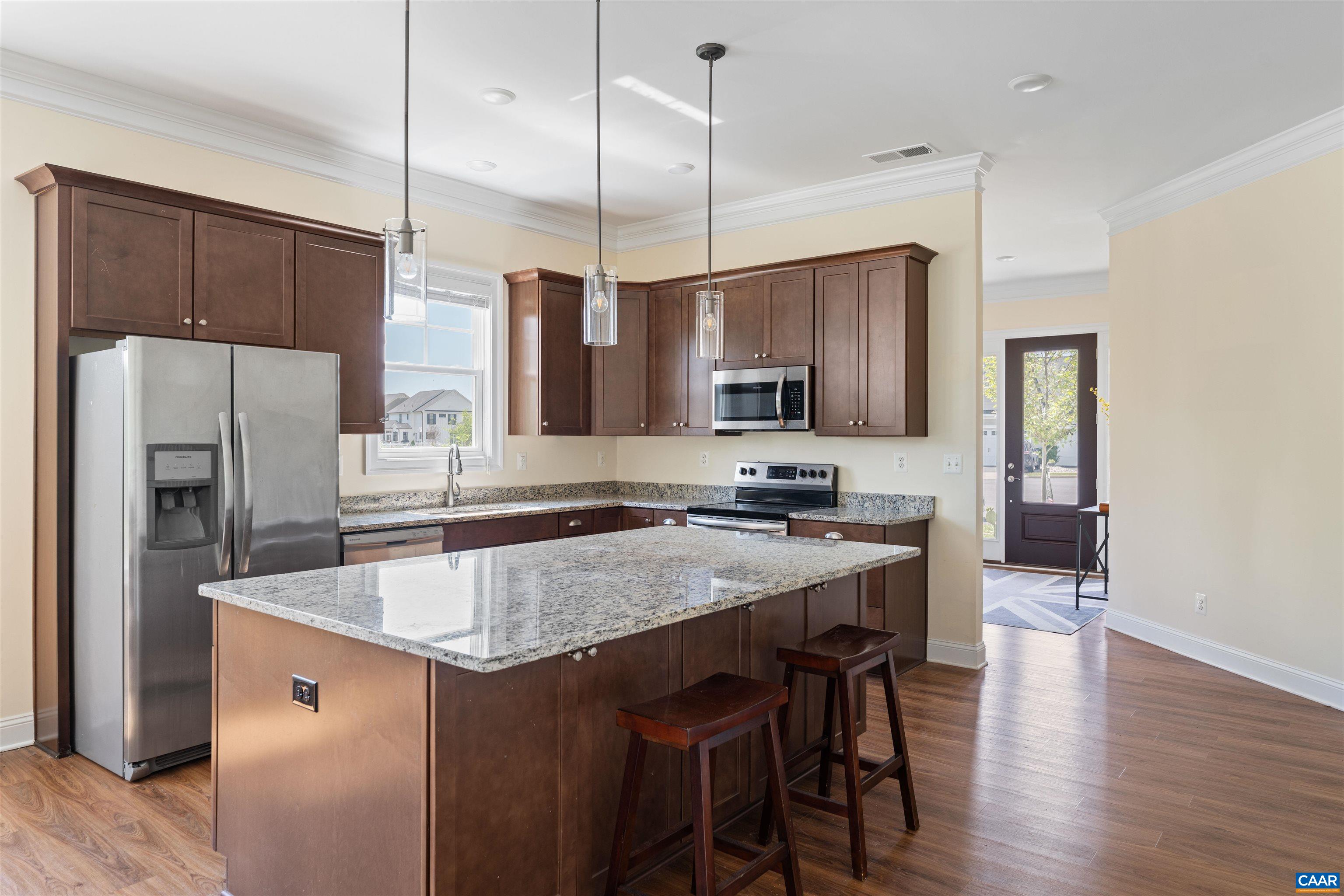 322 Claibourne Road Crozet, VA 22932 - Photo 7 of 25 a kitchen with stainless steel appliances granite countertop a sink a stove a refrigerator a center island a stove and wooden floor