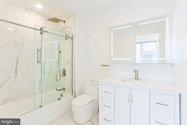 a bathroom with a sink toilet a shower and a bathtub