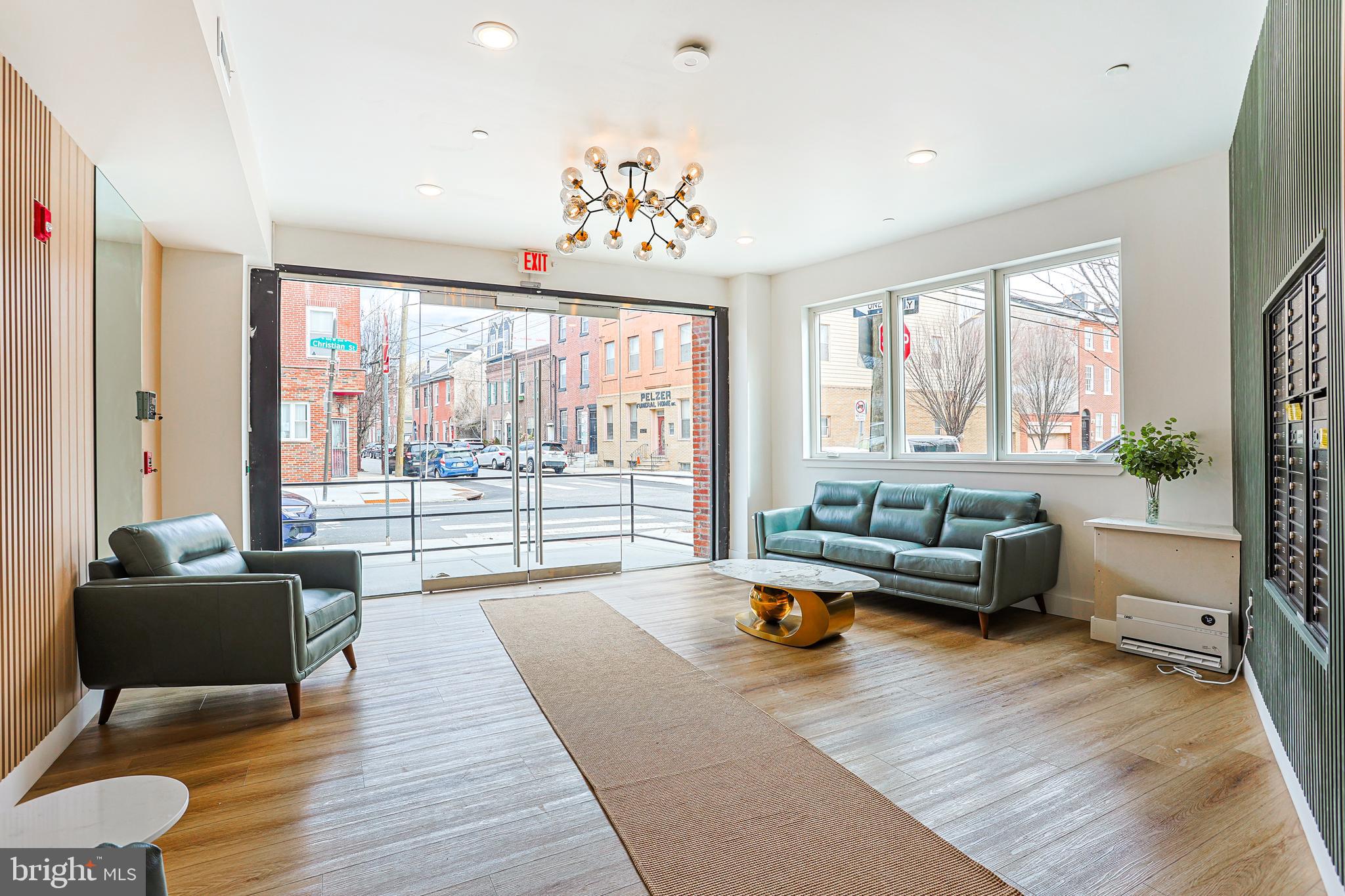 300 Christian Street, Unit 305 Philadelphia, PA 19147 - Photo 3 of 20 a living room with furniture and a large window