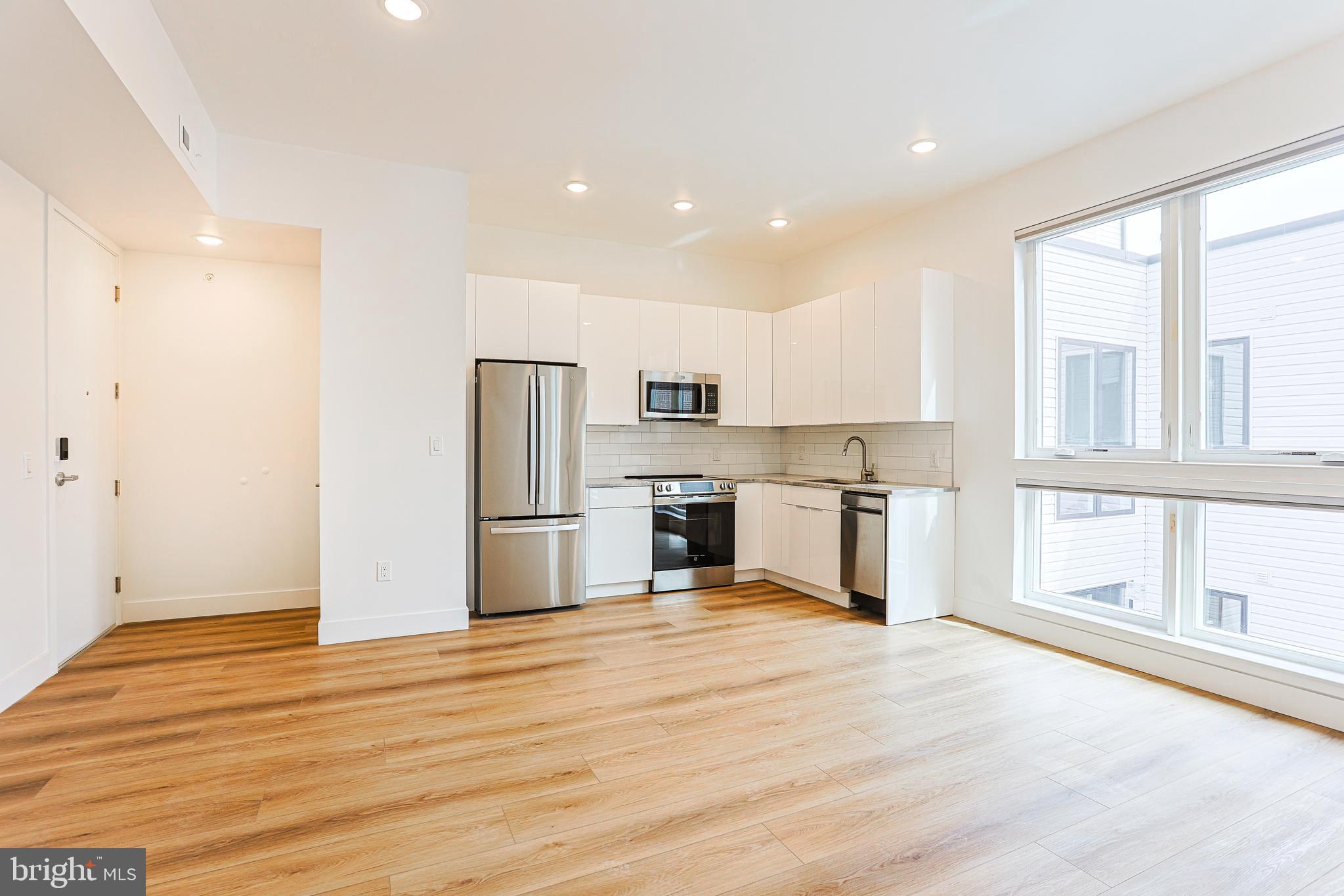 300 Christian Street, Unit 305 Philadelphia, PA 19147 - Photo 6 of 20 a view of kitchen with wooden floor
