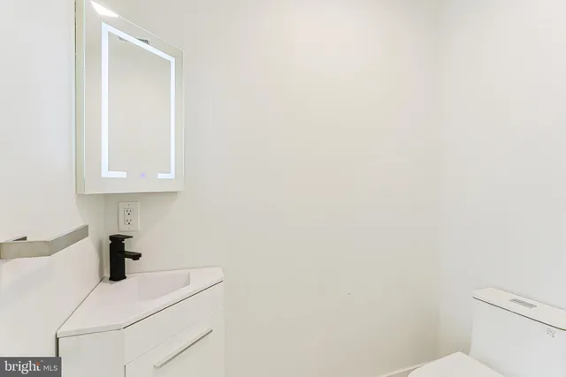 a bathroom with a white toilet and sink