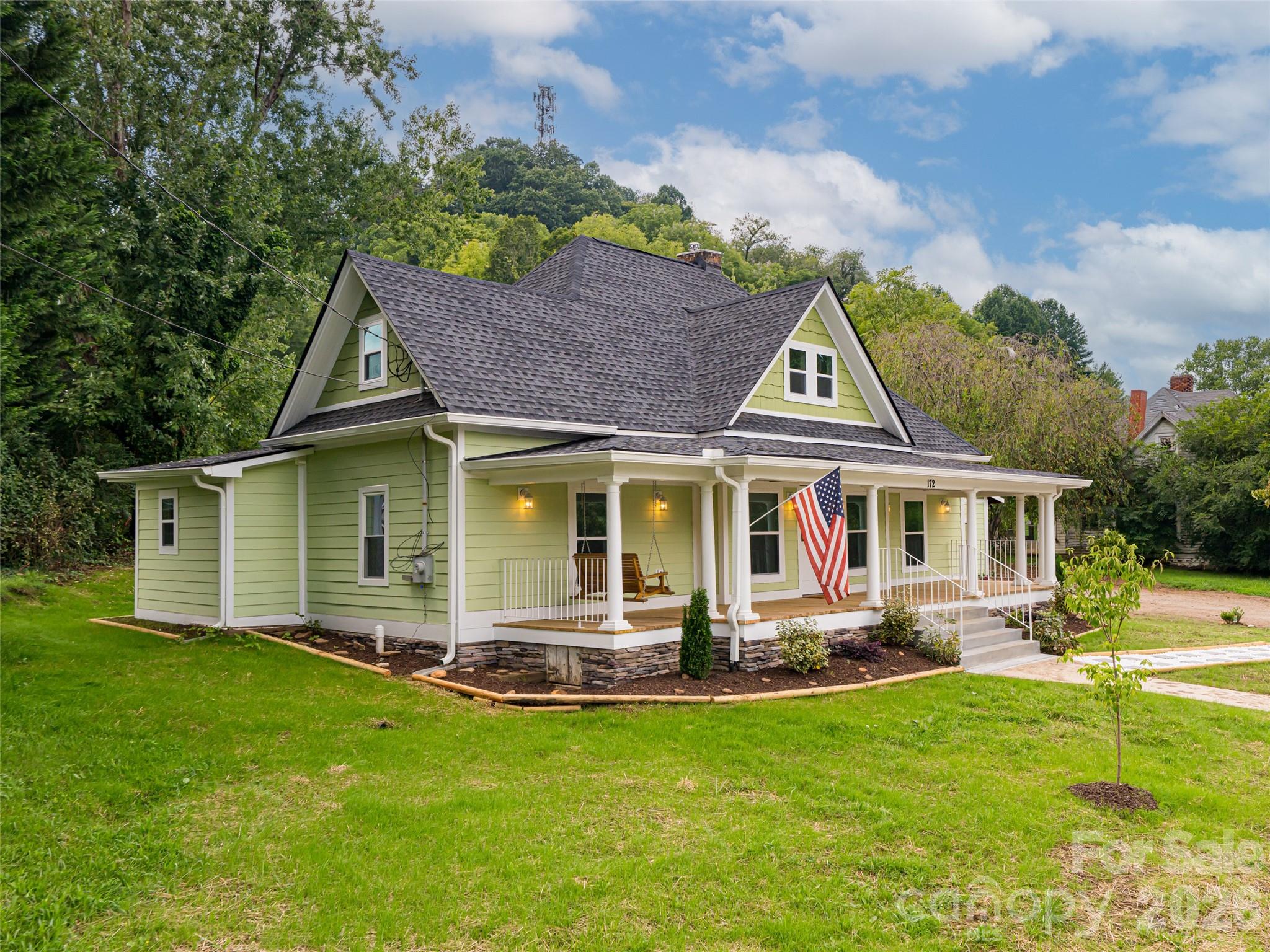 a front view of house with yard and green space
