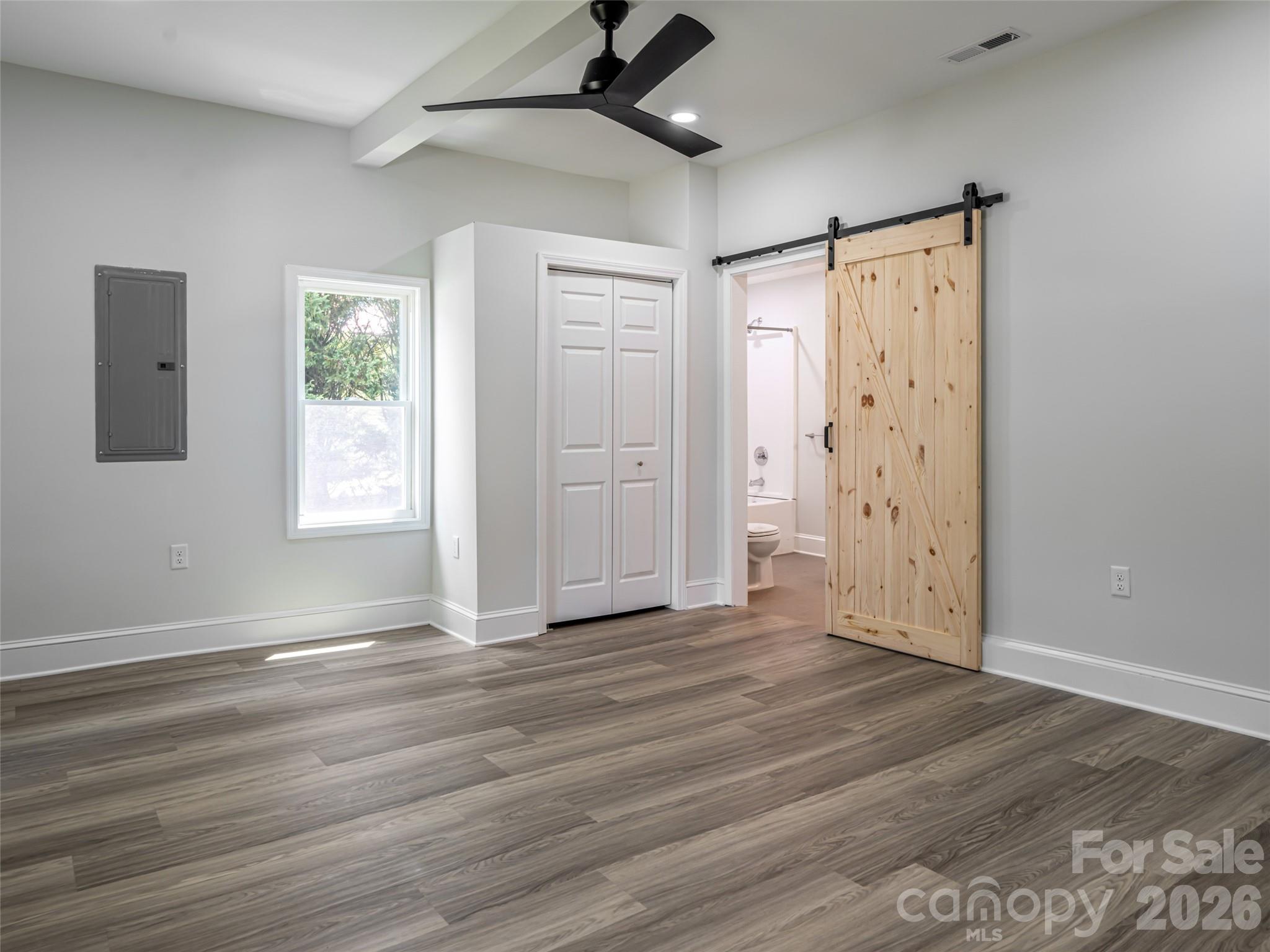 172 Reed Street Canton, NC 28716 - Photo 11 of 48 a view of an empty room with wooden floor and a window