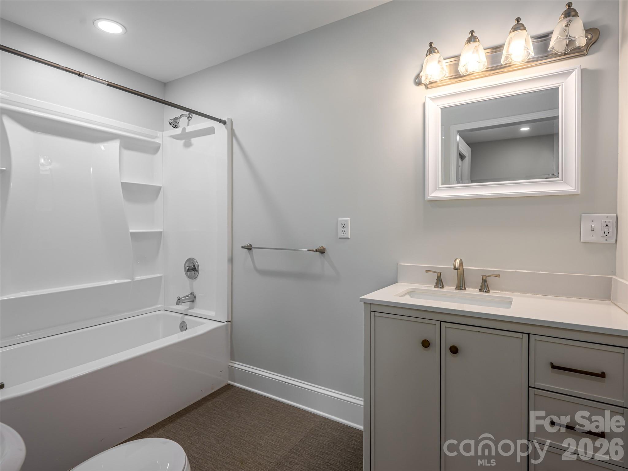 172 Reed Street Canton, NC 28716 - Photo 13 of 48 a bathroom with a bathtub sink vanity and mirror