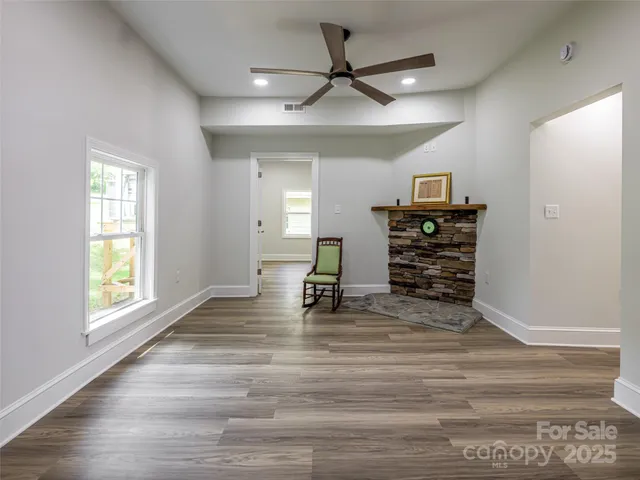 a view of room with a window and wooden floor