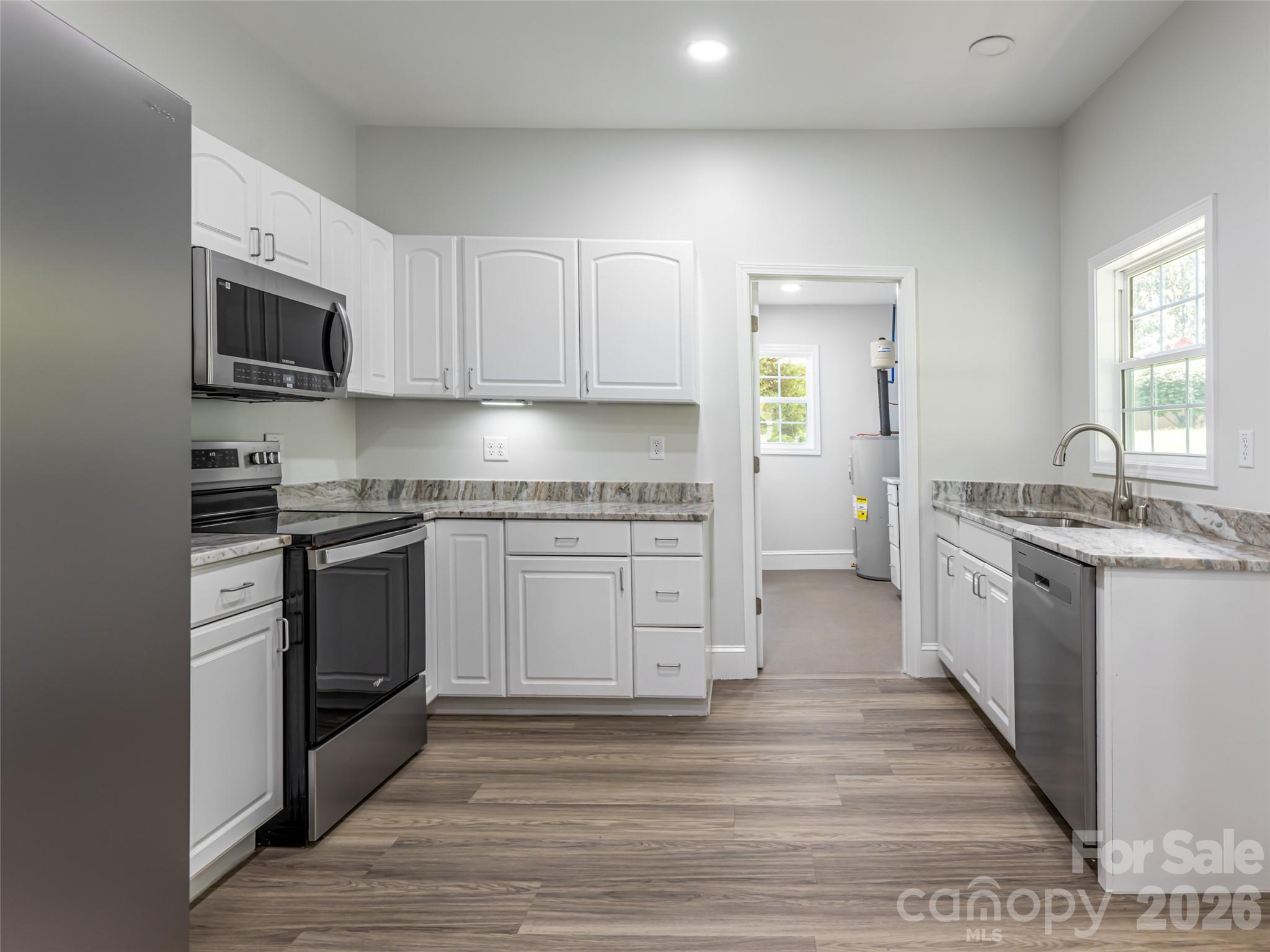 172 Reed Street Canton, NC 28716 - Photo 15 of 48 a kitchen with granite countertop a sink cabinets stainless steel appliances and a window