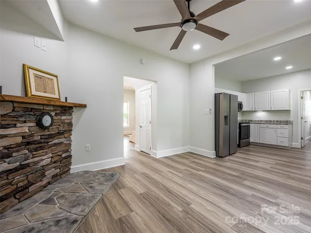a view of a kitchen with a sink and a refrigerator
