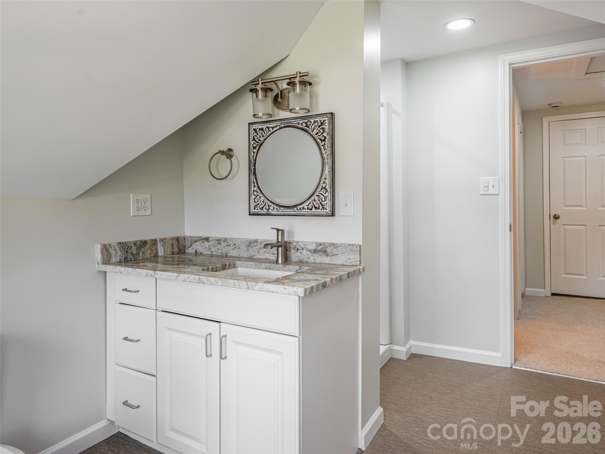 172 Reed Street Canton, NC 28716 - Photo 27 of 48 a bathroom with a granite countertop sink and a mirror