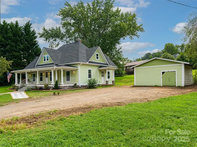 an aerial view of a house with garden space and street view