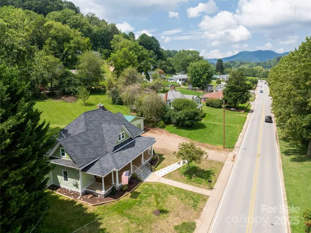 an aerial view of a house with a big yard