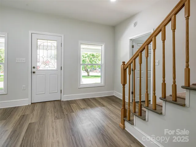a view of an entryway with wooden floor and door