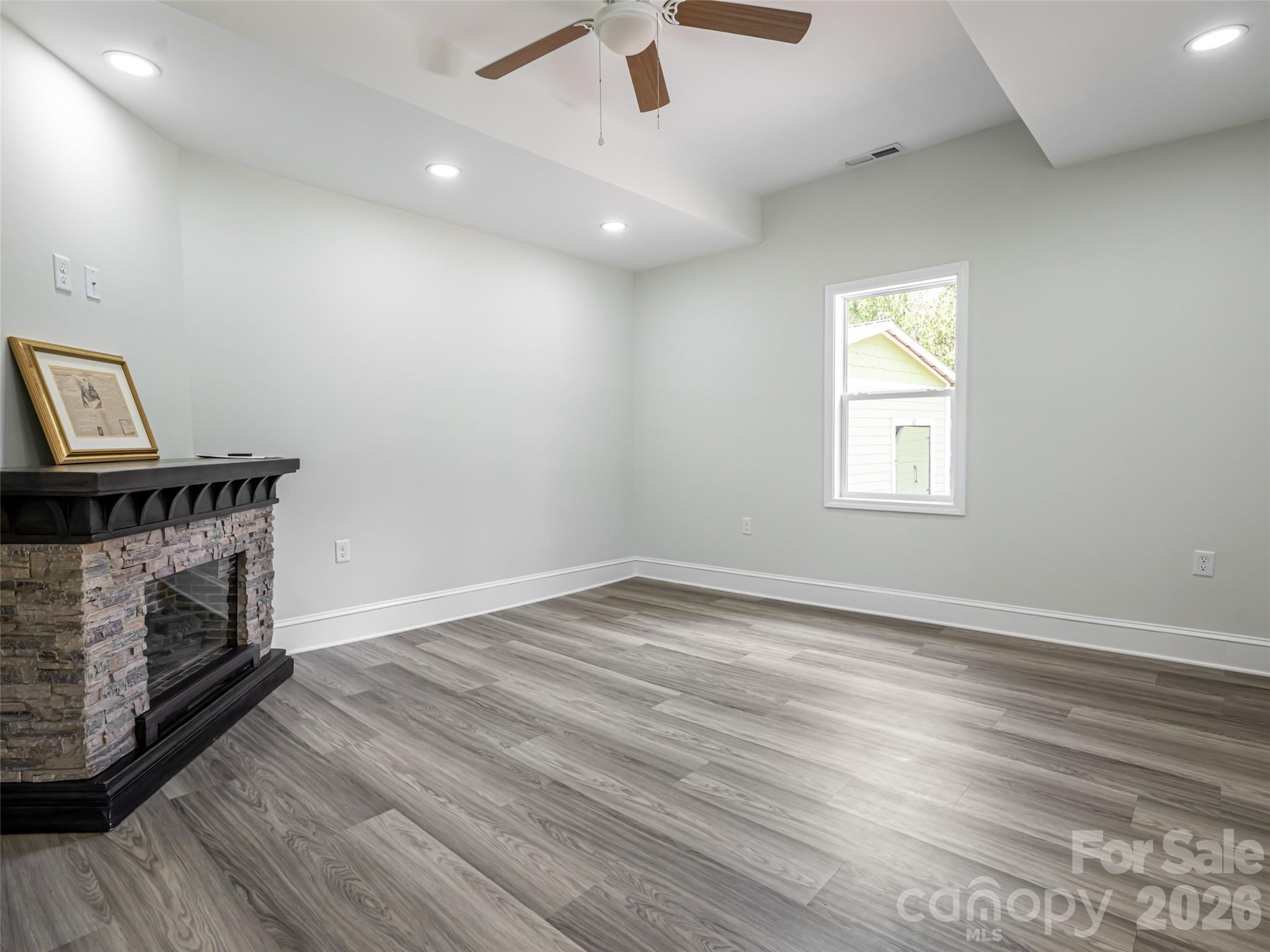 172 Reed Street Canton, NC 28716 - Photo 7 of 48 an empty room with windows and fireplace