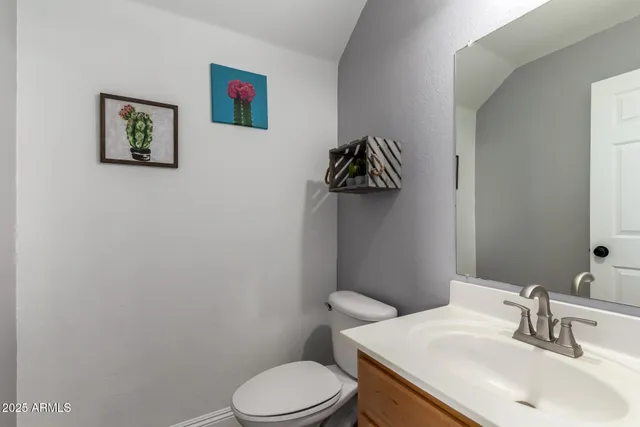 a white toilet sitting next to a bathroom sink