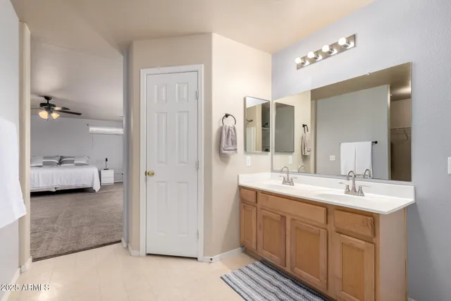 a en suite bathroom with a double vanity sink mirror and shower